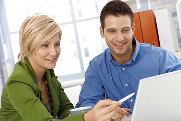 Woman and Man Pointing at Computer Woman and Man Pointing at Computer